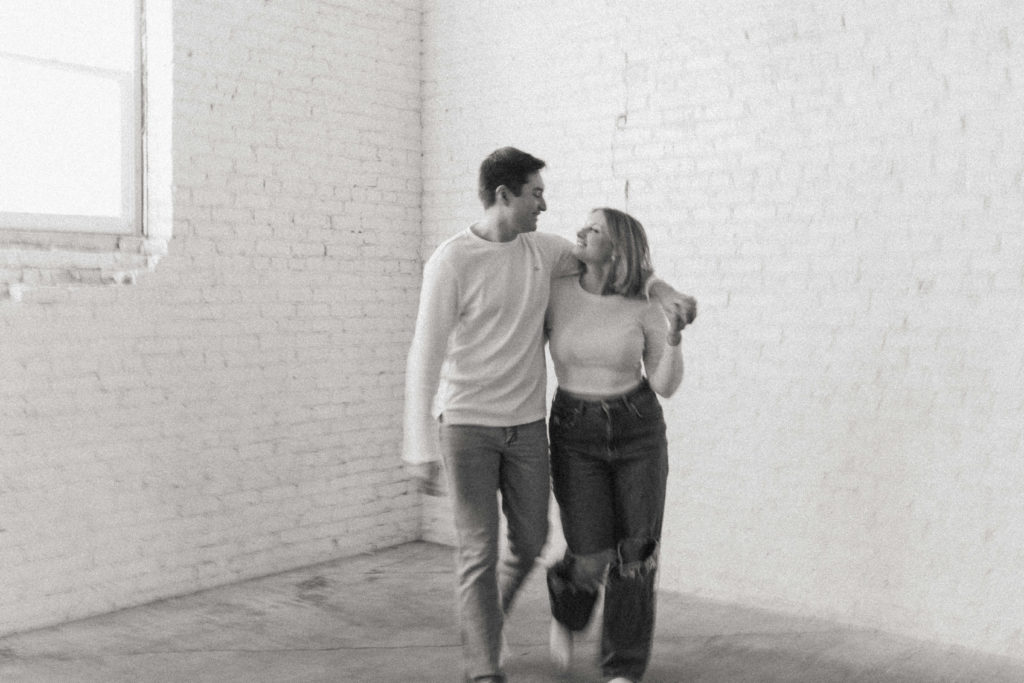 blurry black and white photo of couple walking 