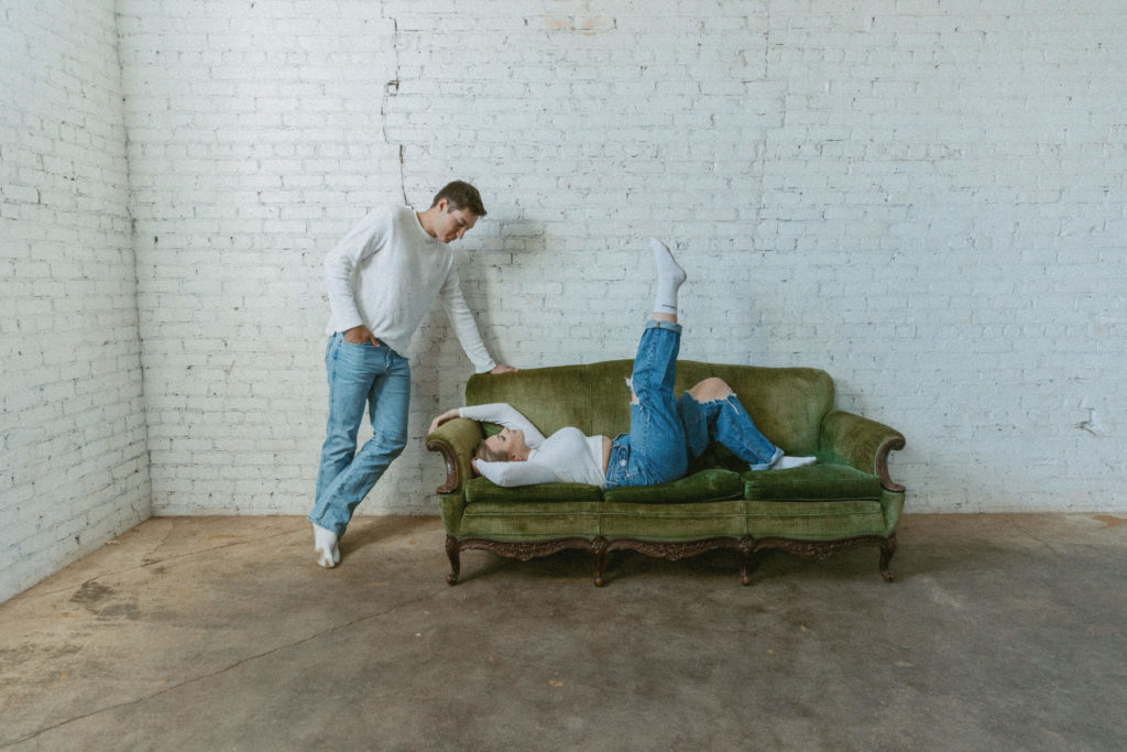 couple posing on a couch 