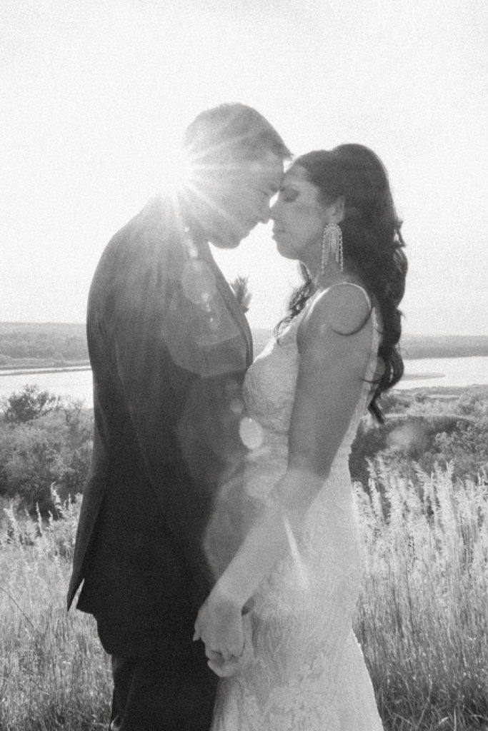 black and white photo of bride and groom face to face 