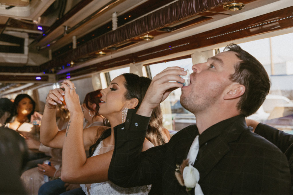 bride and groom taking shots 