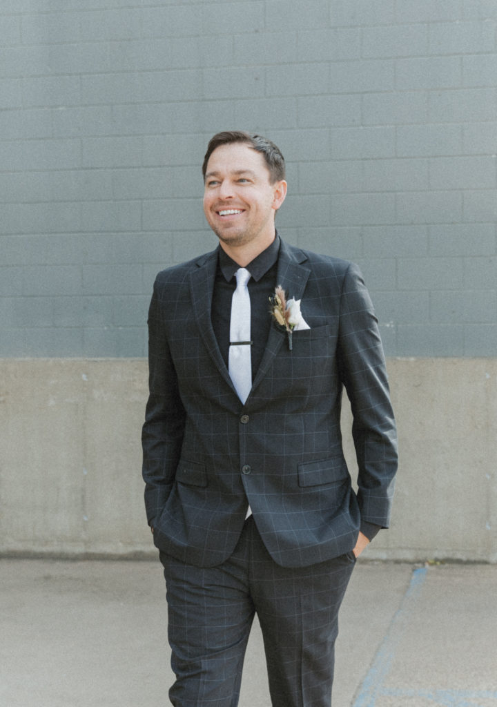groom laughing on his wedding day