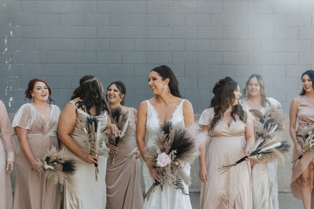 bride and her bridal party laughing 